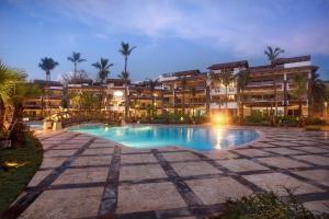 a resort with a swimming pool at night at Xeliter Balcones del Atlantico - Las Terrenas in Las Terrenas