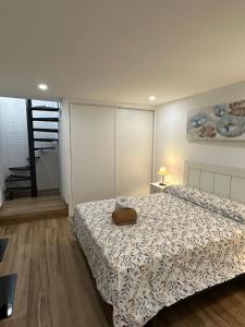 a bedroom with a bed and a staircase at Apartamentos Bravo Murillo in Madrid