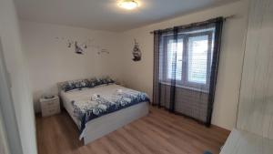 a bedroom with a bed and a large window at ADRIATIC APARTMENT center II MAKARSKA in Makarska