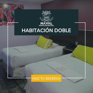 two beds in a hotel room with ahibraction double at Hostal NAVAL in La Paz