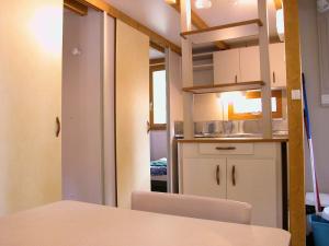 a small kitchen with a table and a room at Camping El Balcon de Pitres in Pitres