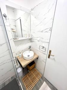 a white bathroom with a sink and a toilet at Sun&Fun Studio Apartment in Hvar