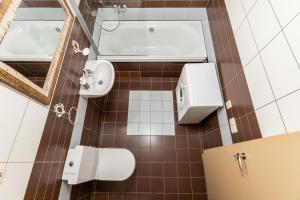 a bathroom with a toilet and a sink and a mirror at CAMELIA CENTRE APARTMENT in Palanga +13 photos