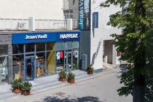 a store front with potted plants in front of it at CAMELIA CENTRE APARTMENT in Palanga