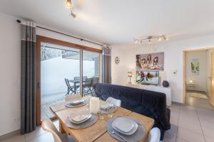 a living room with a table and a couch at Les Loges Blanches - Apt B103 - BO Immobilier in Châtel