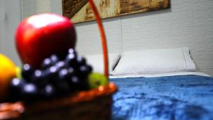 Casinha في بورتو أليغري: غرفة بها سرير وصحن من الفواكه