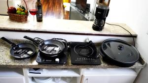 a kitchen counter with two pots and pans on it at Casinha in Porto Alegre