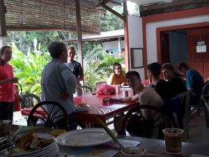 a group of people sitting around a table at MULU BACKPACKER HOMESTAY in Mulu