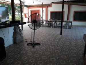 a room with a fan in the middle of a room at MULU BACKPACKER HOMESTAY in Mulu