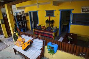 an overhead view of a living room with a guitar at Residencial Caetanos - 5 casas em Arraial D'ajuda in Porto Seguro
