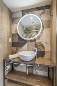 a bathroom with a sink and a mirror at Studio 21 with kitchenette at the new Olo living in Paceville