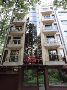 un condominio alto con un cartello sopra di Favorit Hotel a Sofia