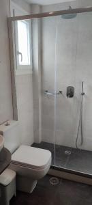 a bathroom with a toilet and a glass shower at Maria Studios in Parikia