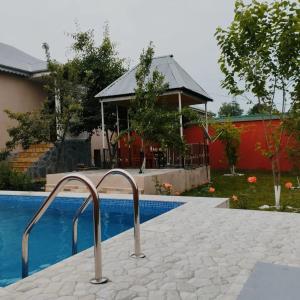 a resort with a swimming pool and a gazebo at Samist Villa in Gabala