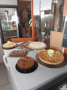 a table with several cakes and pies on it at Pura Vida El Molle in Vicuña
