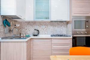 a kitchen with white cabinets and a sink at Fieschi 316 Marola, Terre Marine in La Spezia