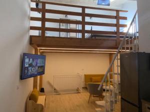 a room with a staircase with a tv and a living room at Casa del Vicolo in Alghero