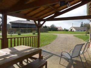 a patio with a table and chairs on a porch at GITE DU PUITS DE LA BARRE in Sompt +10 photos