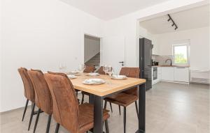 - une salle à manger avec une table et des chaises en bois dans l'établissement Awesome Home In Bilice With Wifi, à Bilice