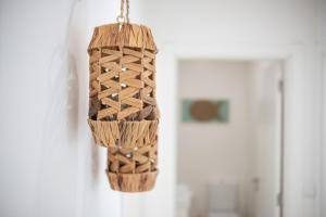 a wooden chandelier hanging on a wall at Iris Apartment in Nazaré