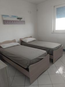 מיטה או מיטות בחדר ב-villa,Salentina, marina di Mancaversa