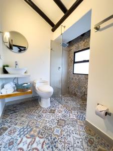a bathroom with a toilet and a sink at Estudia y trabaja sin límites en Hacienda Loretto con Starlink!! in Silvania