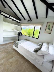 a bedroom with a bed and a window at Estudia y trabaja sin límites en Hacienda Loretto con Starlink!! in Silvania