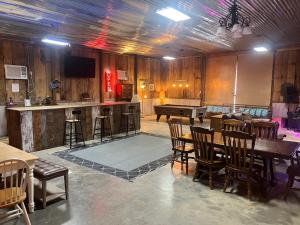 a large room with a table and a piano at Buddy's Harbor in Lake Ozark