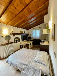 a bedroom with a large bed and a kitchen at Villa Elisa in Scarperia