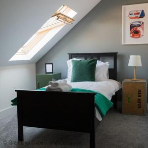 a bedroom with a bed with green and white at Number 5 Steading Cottage in Banchory