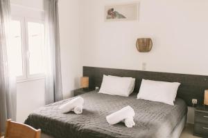 a bedroom with a bed with two towels on it at Grey House in Chorafakia +44 photos