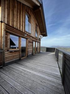 a wooden deck on the side of a house at Höhenchalet Klippitz in Bad Sankt Leonhard im Lavanttal