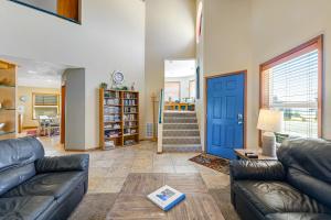 a living room with a couch and a blue door at Cape Escape in Pacific City