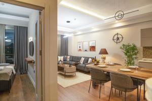 a living room with a couch and a table at Sirius Town by AntalyaSuites in Antalya