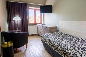 a hotel room with a bed and a desk and a window at Tähetorni Hotel in Tallinn