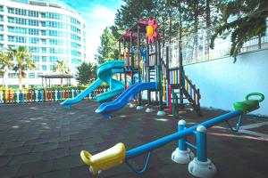 a playground with a slide in a park at Sirius Town by AntalyaSuites in Antalya