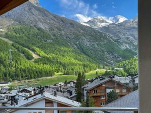 a view from a window of a town with a mountain at Victoria's Home - luxurious penthouse in Saas-Fee