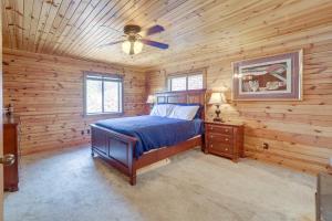 a bedroom with a bed in a log cabin at Payson Cabin with Deck Near Hiking, Fishing and More! in Payson