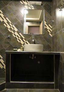 a bathroom with a sink and a mirror at Villa Vayia in Stavros +38 photos