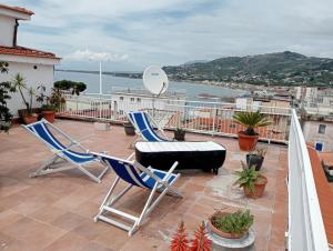 a patio with two chairs and a table on a balcony at Cala Licina in Agropoli +11 photos
