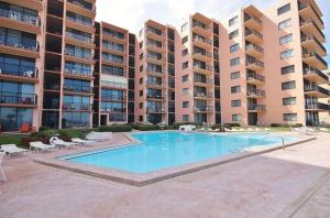 a swimming pool in front of some apartment buildings at Sunrise 109 in New Smyrna Beach