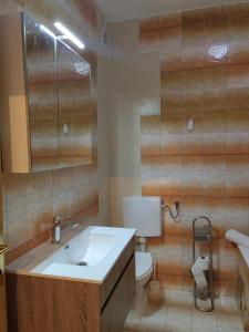 a bathroom with a sink and a toilet at Apartment Kate in Stobreč