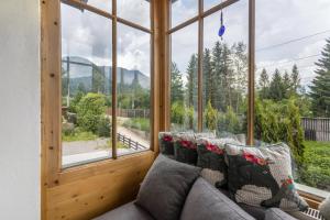 a living room with a couch and a large window at Kitzchalet in Kitzbühel