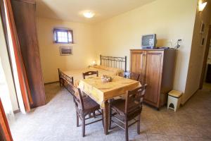 a dining room with a table and chairs and a television at Appartamento Il Golfo in Portoferraio