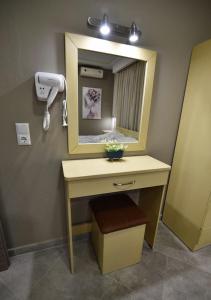 a bathroom with a vanity with a mirror and a hair dryer at Villa Vayia in Stavros
