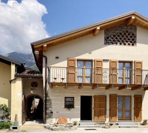 a house with a balcony on top of it at BALLABIO LAKE - Rustic Chic Retreat in Ballabio