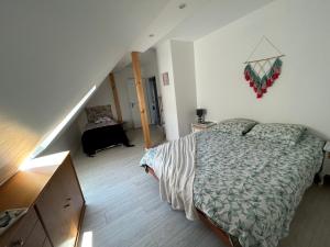 a small bedroom with a bed and a staircase at GITE MA MAISON in Kintzheim