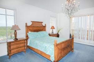Un dormitorio con una cama y una lámpara de araña. en Mallorca 506, en New Smyrna Beach