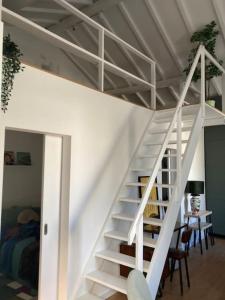 a white staircase leading up to a loft bed at Oporto city center charming house in Porto