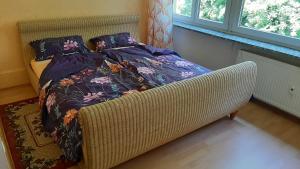 uma cama com um cobertor e almofadas num quarto em Oase der Ruhe und Entspannung em Bad Homburg vor der Höhe